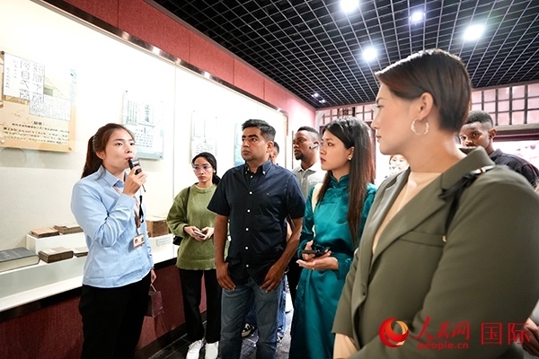 選手們認(rèn)真聆聽導(dǎo)游講解。人民網(wǎng) 盧鵬宇攝