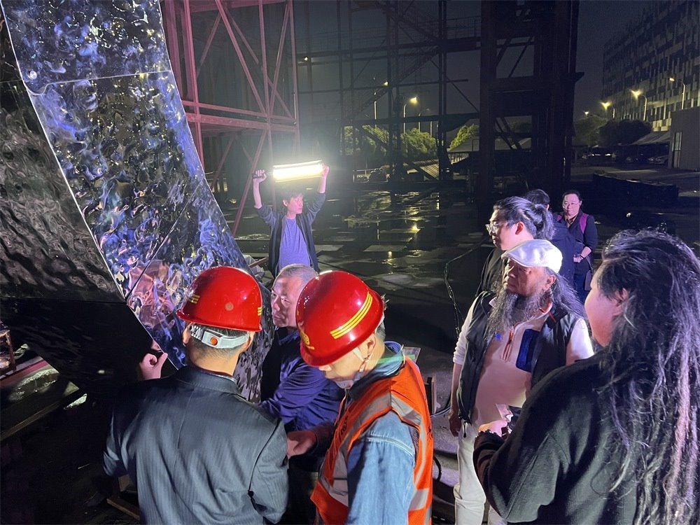 林崗（右二）和團(tuán)隊(duì)查看主火炬制作進(jìn)度。受訪者供圖