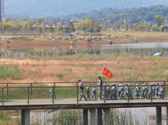 10月24日，秋游的幼兒園小朋友在老師帶領(lǐng)下走在清水塘公園里的木橋上。本報(bào)記者 常雯宜攝