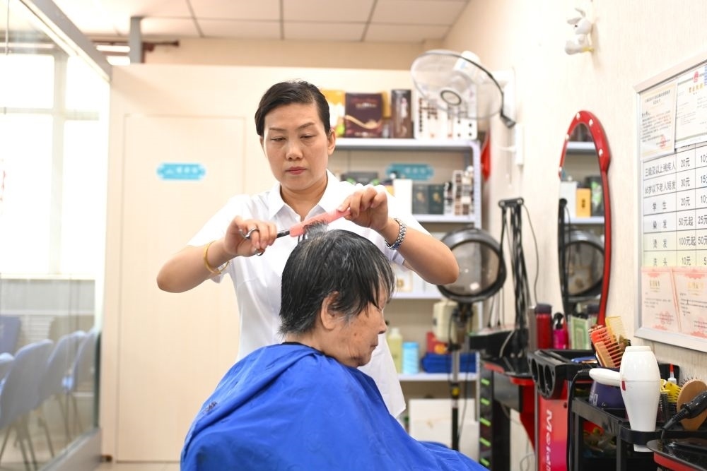 6月20日，長(zhǎng)城花園社區(qū)的志愿者為居民理發(fā)。