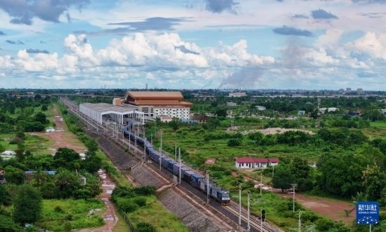 8月5日，由老撾籍火車司機(jī)獨(dú)立駕駛的滿載貨物的列車駛出萬象站，向中國昆明進(jìn)發(fā)（無人機(jī)照片）。新華社發(fā)（楊永全 攝）