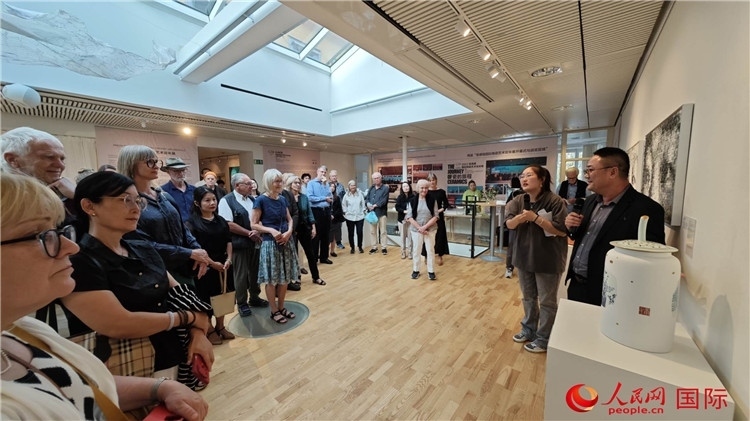 參展人、景德鎮(zhèn)陶瓷大學(xué)美術(shù)學(xué)院副院長(zhǎng)邵長(zhǎng)宗（右一）向來賓介紹參展作品。人民網(wǎng)記者 殷淼攝